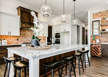 A kitchen with a large island and stools.