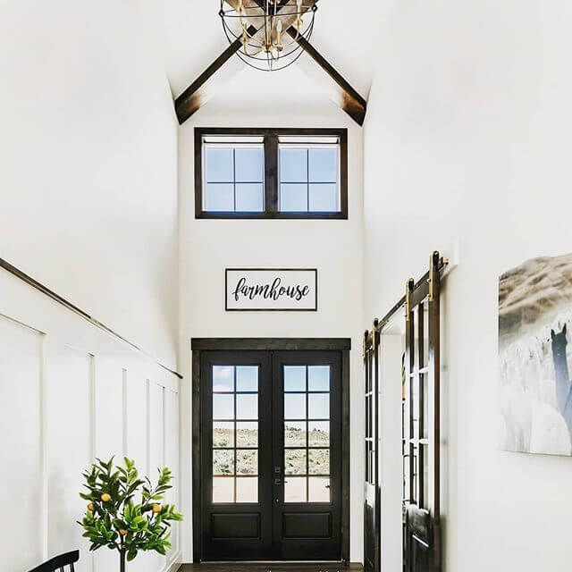 A hallway with a sign on the wall that says farmhouse