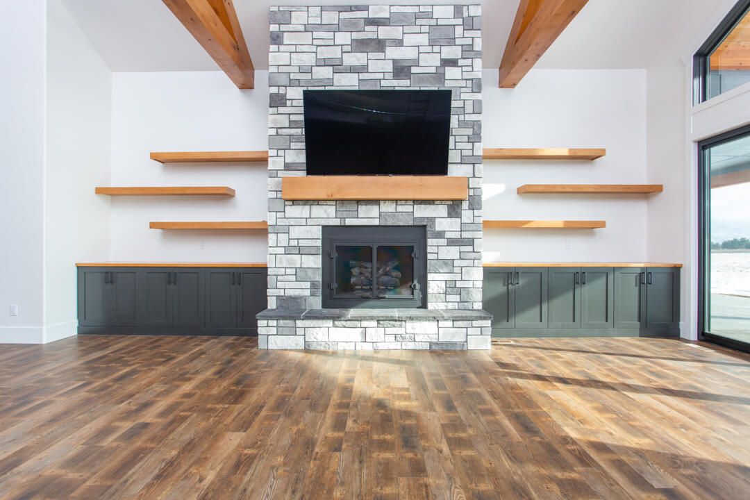 A living room with a fireplace and a flat screen tv.