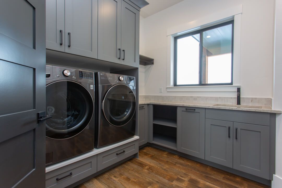 A laundry room with a washer and dryer and a window.