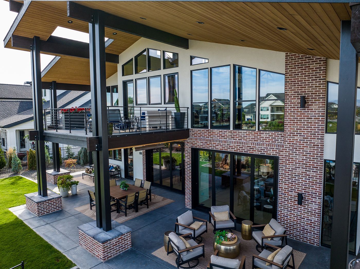 An aerial view of a large house with a lot of windows and furniture.
