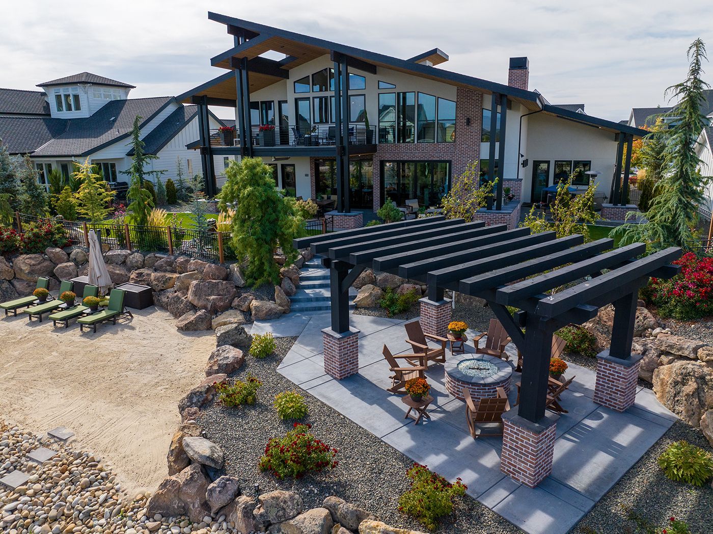An aerial view of a large house with a pergola in front of it.