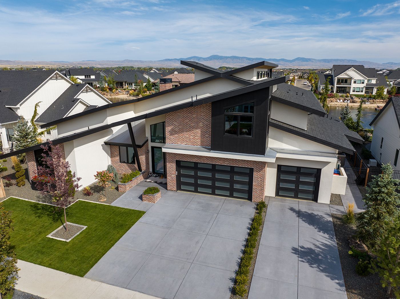 An aerial view of a modern house in a residential area.