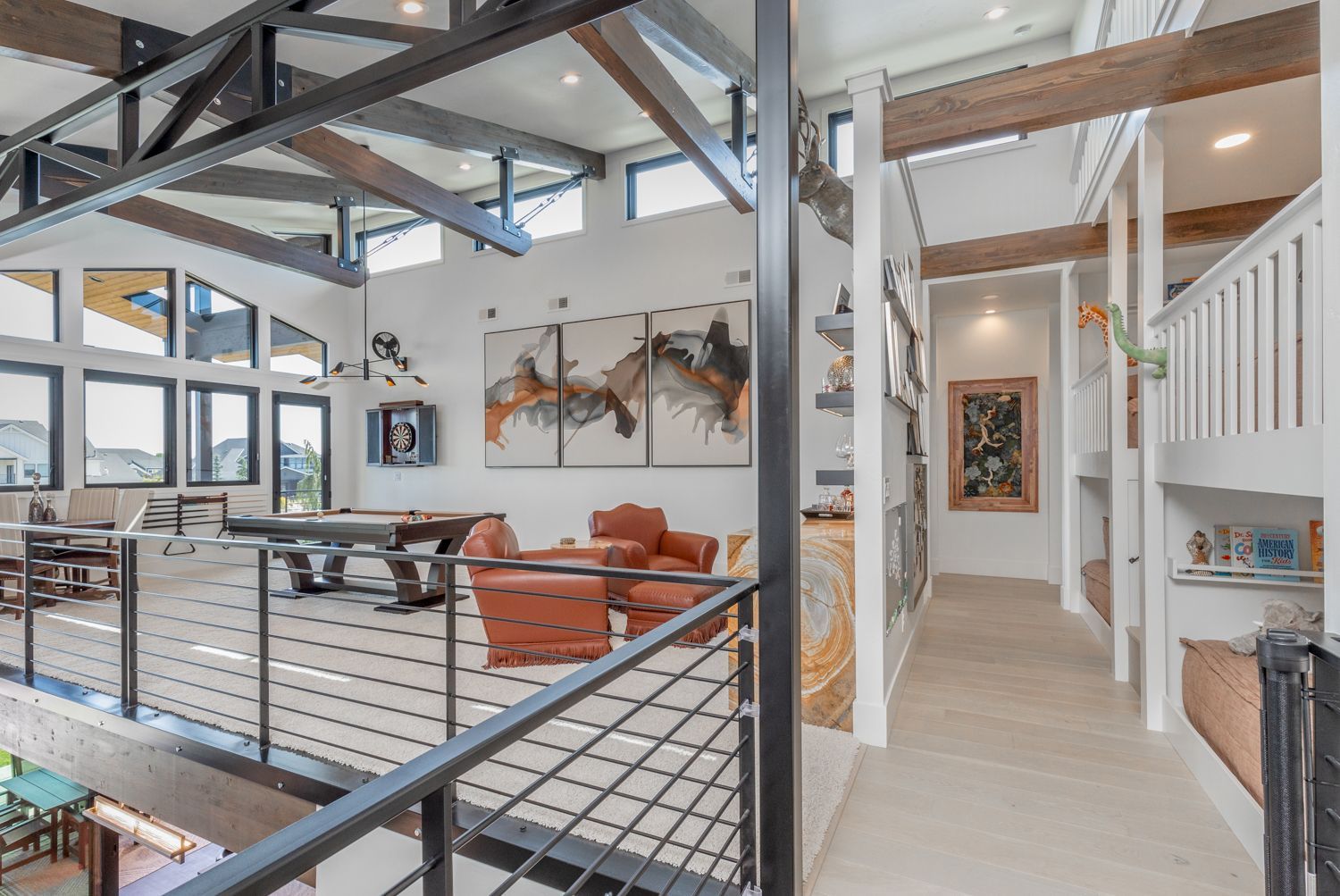A view of a living room from the second floor of a house.