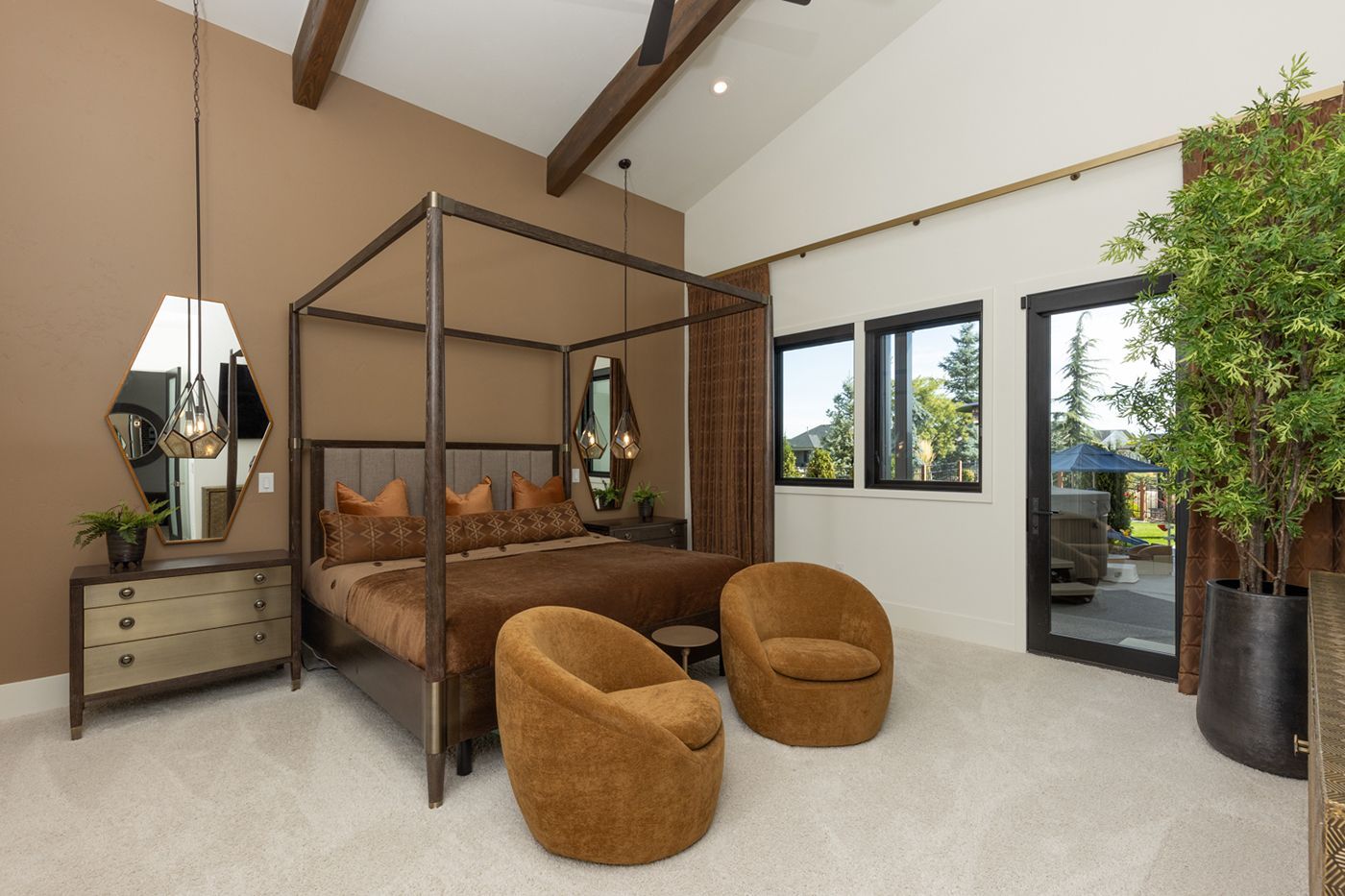 A bedroom with a canopy bed and two chairs