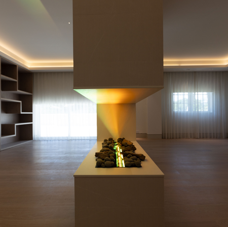 A room with a fireplace in the middle of it