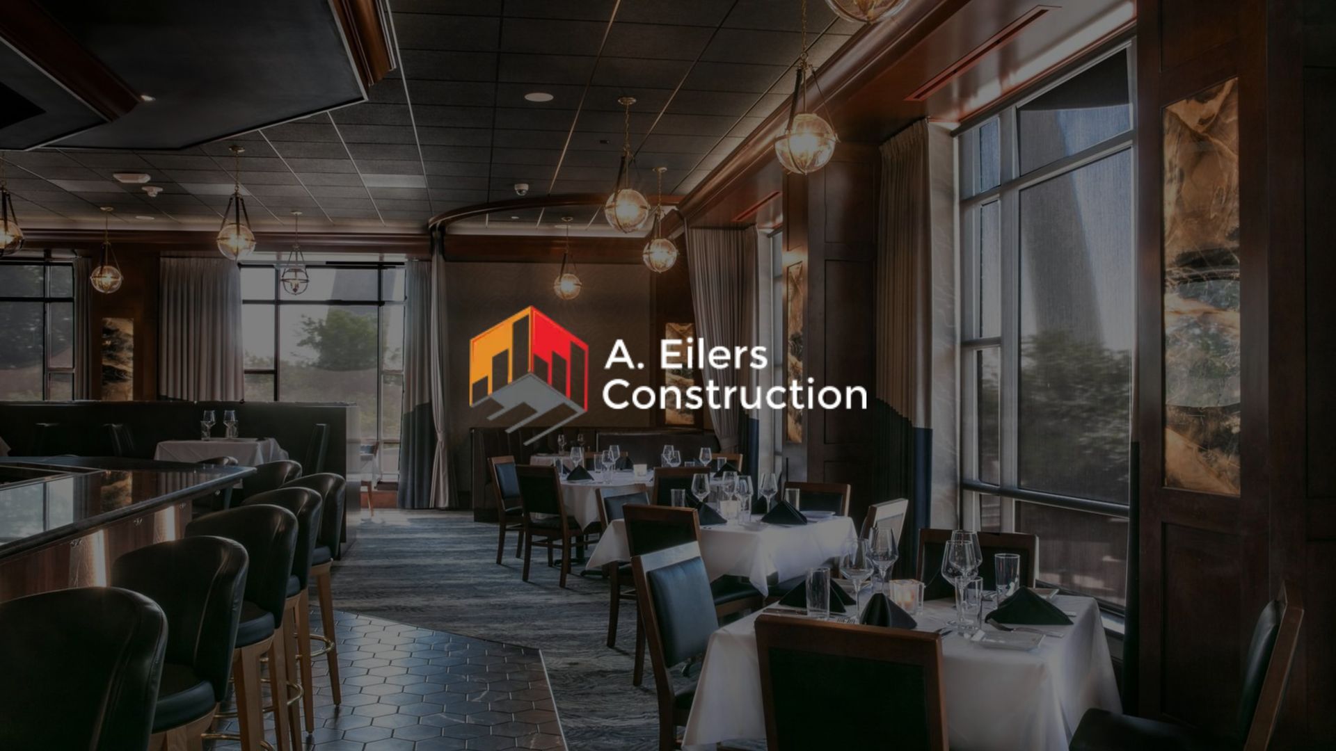 Elegant restaurant interior with tables and chairs, overlaid with A. Ellers Construction logo