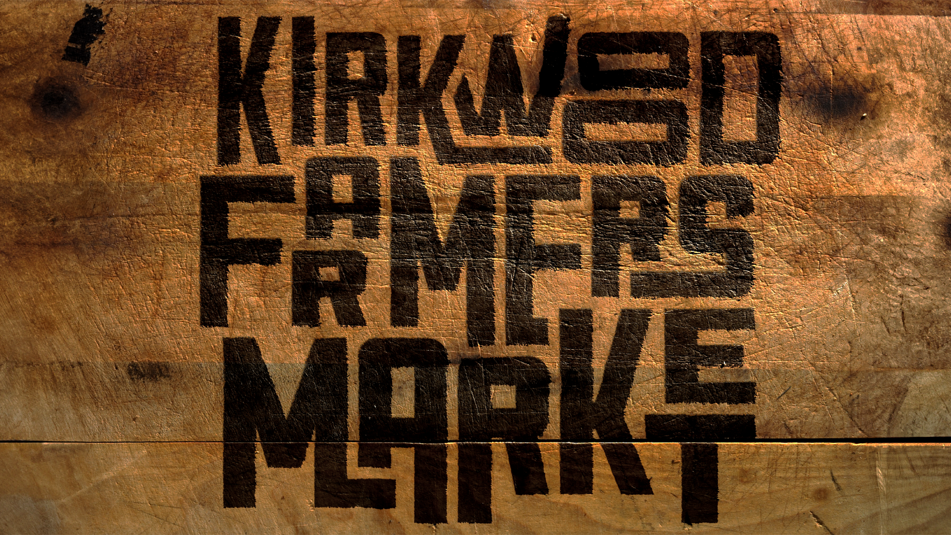 Kirkwood Farmers Market logo in bold black text on a brown textured background