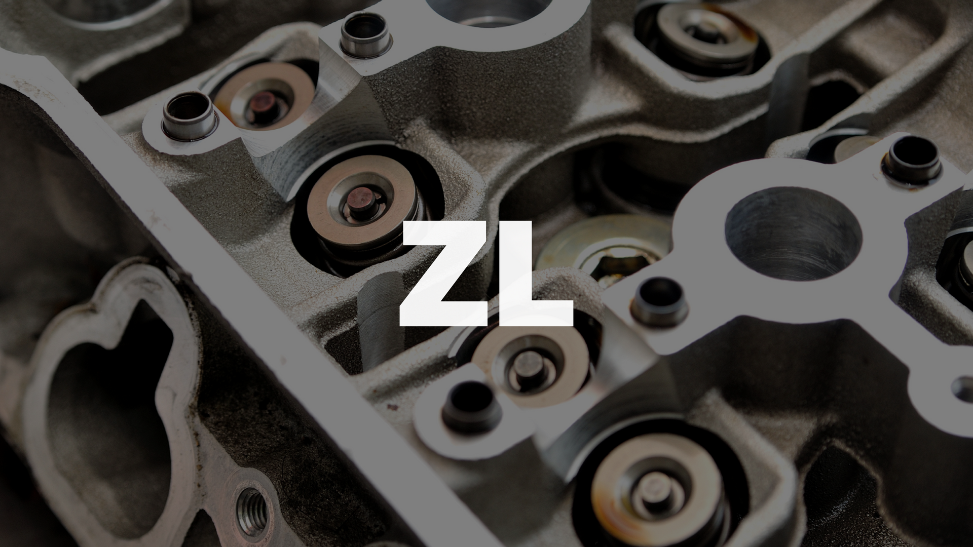 Close-up of metal mechanical parts with a white ZL logo centered over them