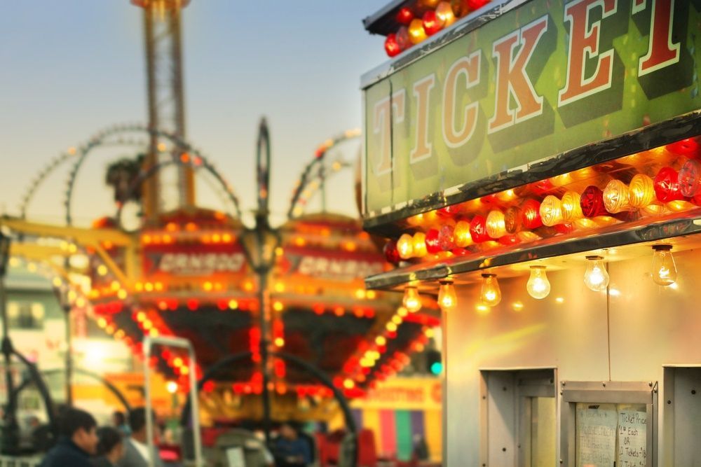 A Ticket Booth at a Carnival With a Roller Coaster in the Background — Sign Media Solutions in Ballina, NSW