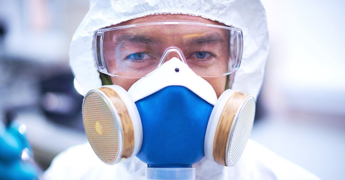 Crime Scene Cleanup a man wearing a gas mask and goggles looks at the camera