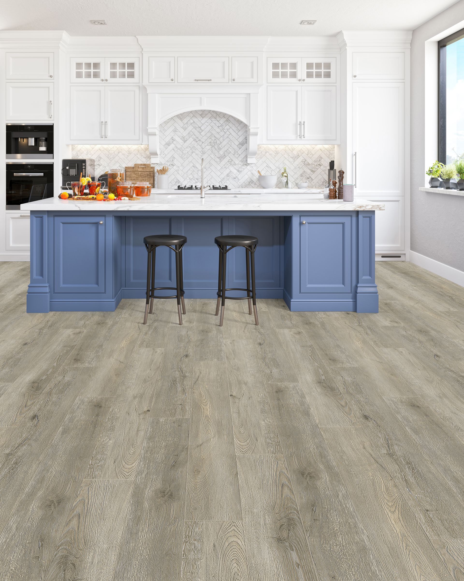 Bright white kitchen with a blue island, two stools, and light wood flooring