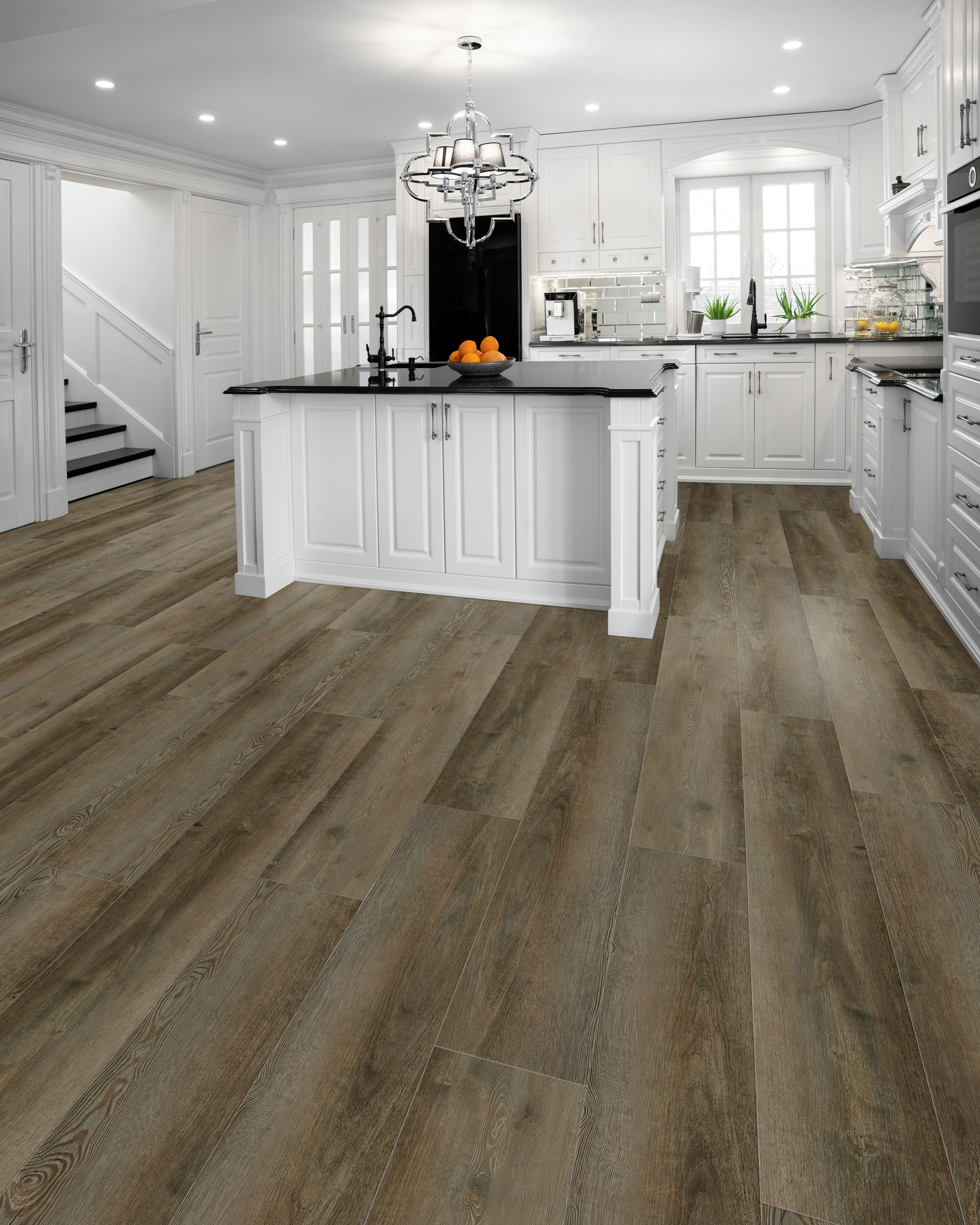 Bright modern kitchen with white cabinets, black island, and wood-look flooring