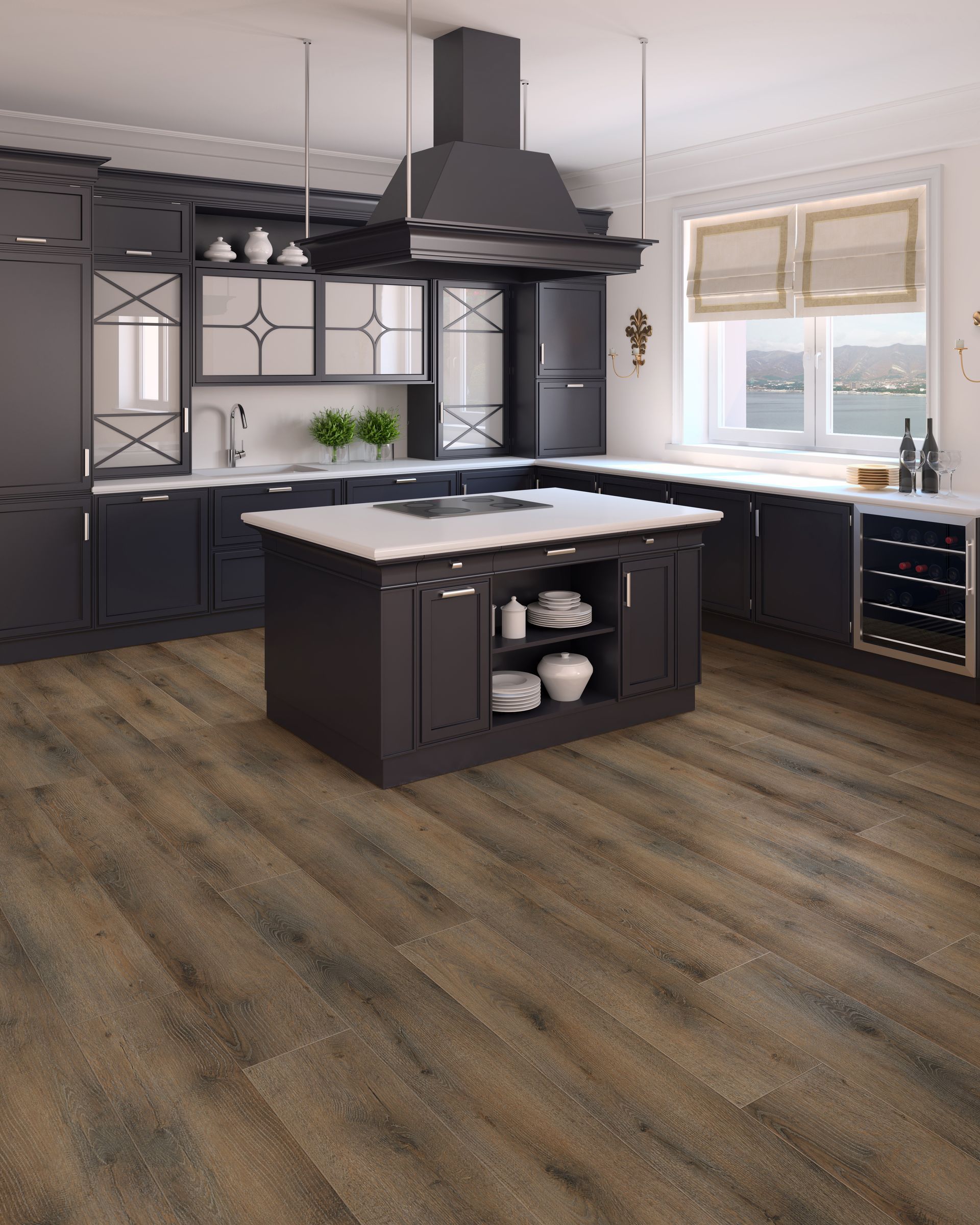 Modern kitchen with dark cabinets, island, white countertops, wood floors, and a large range hood.