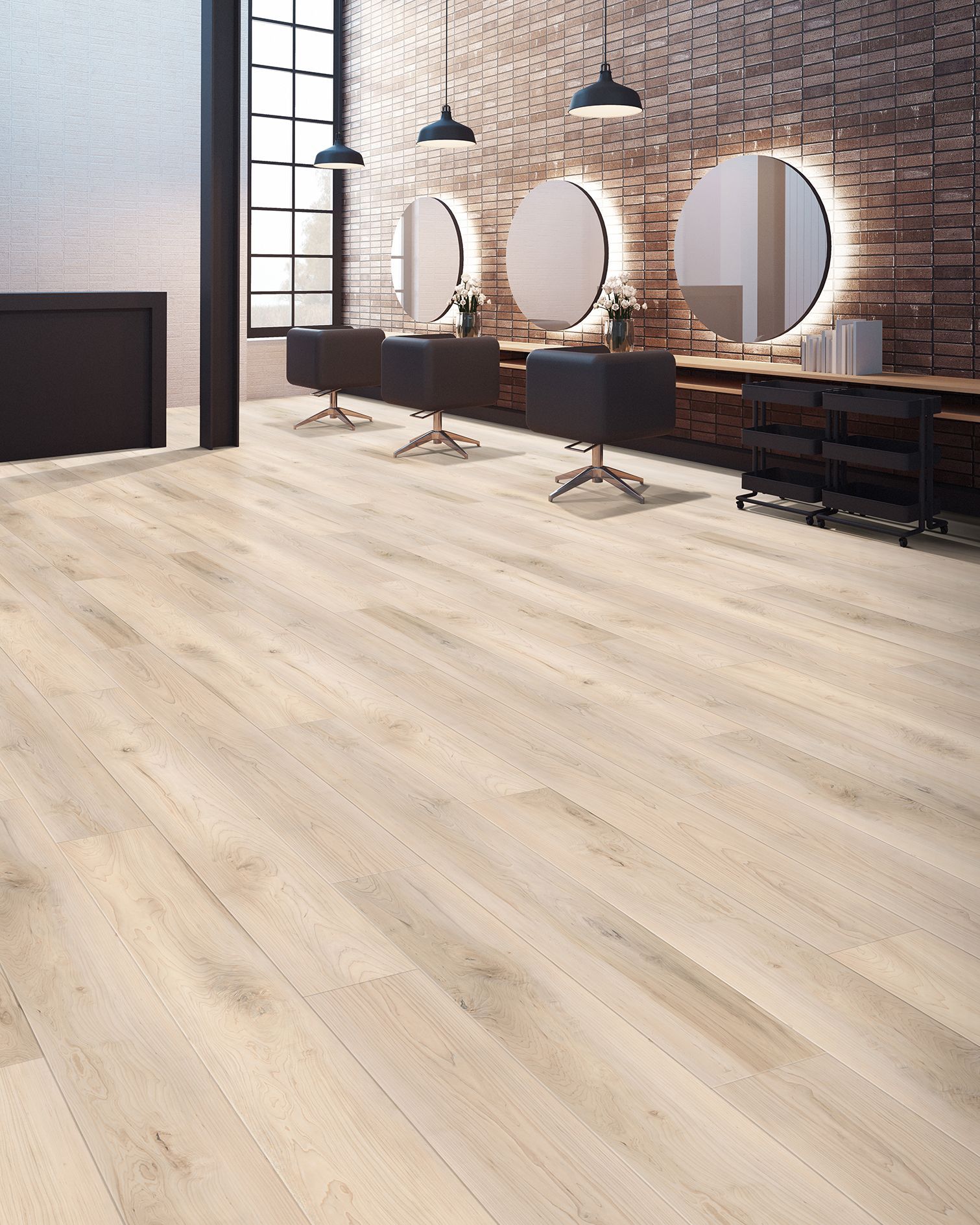 Modern salon with round mirrors, styling chairs, and light wood flooring against a brick wall