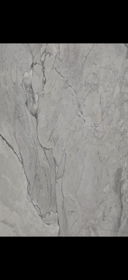 Gray marble tile surface with subtle veining and cracks