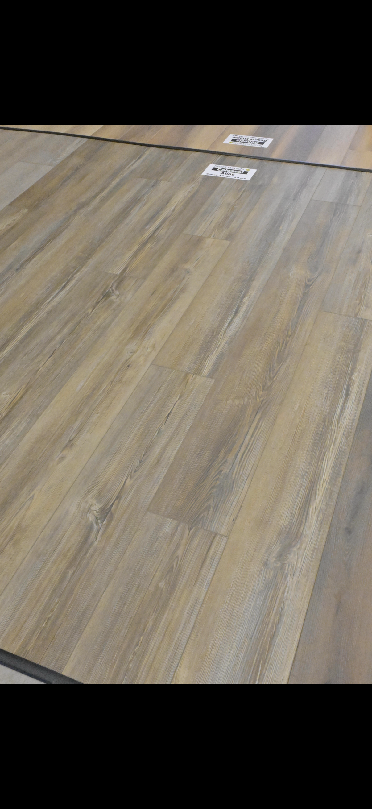 Wooden floor with two small white labels near the top edge