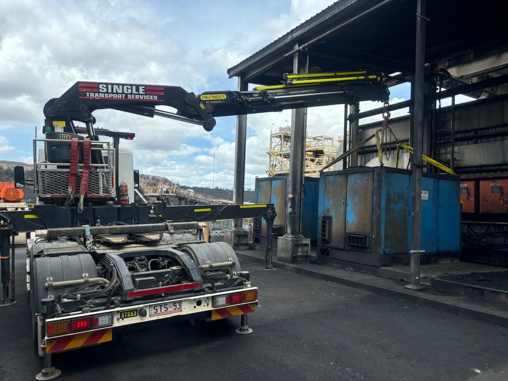 A Yellow Crane Is Lifting A Large White Box — Single Transport Services In Cannonvale, QLD