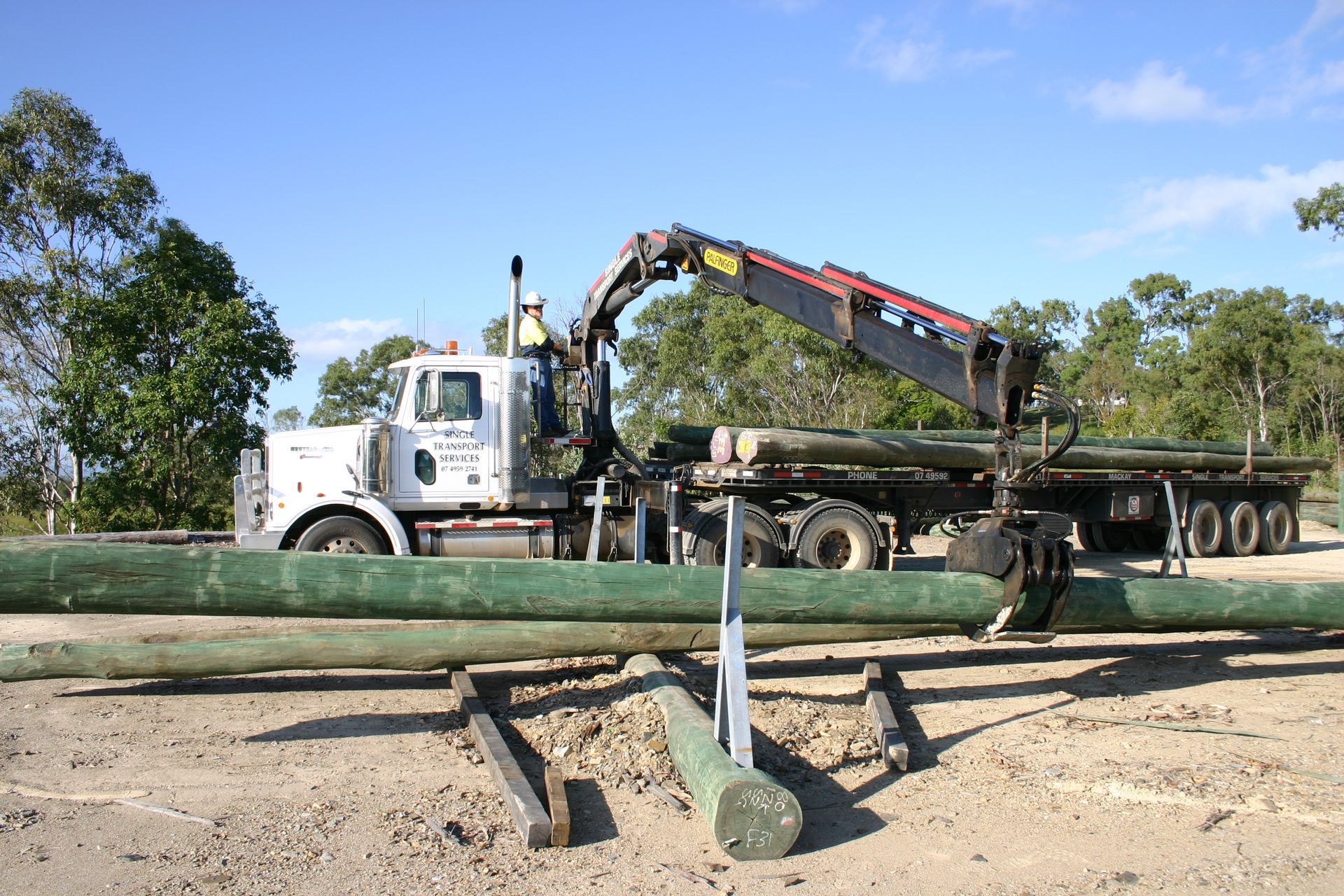 A Crane Is Lifting A House Into The Air — Single Transport Services In Emerald, QLD