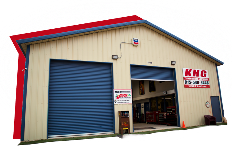 Industrial warehouse with beige siding, blue doors, and red trim, labeled KHG on the front.