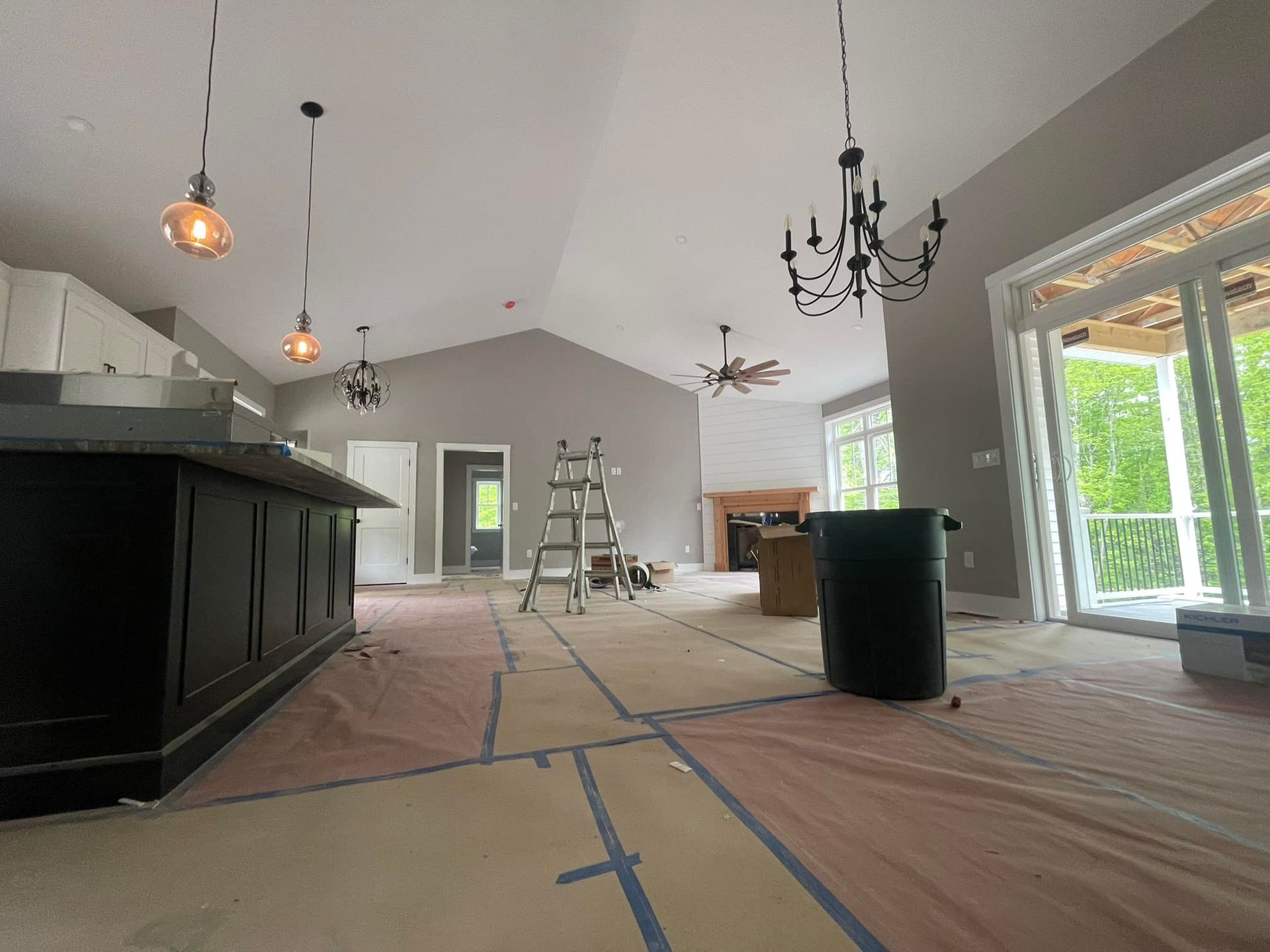 A large room with a lot of windows and a chandelier hanging from the ceiling.