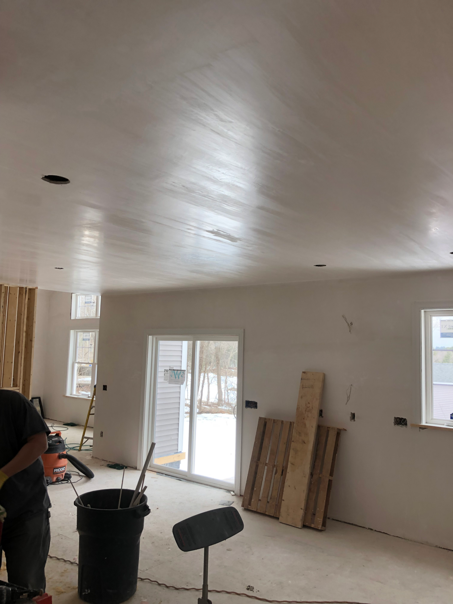 A man is working in a room with a vacuum cleaner