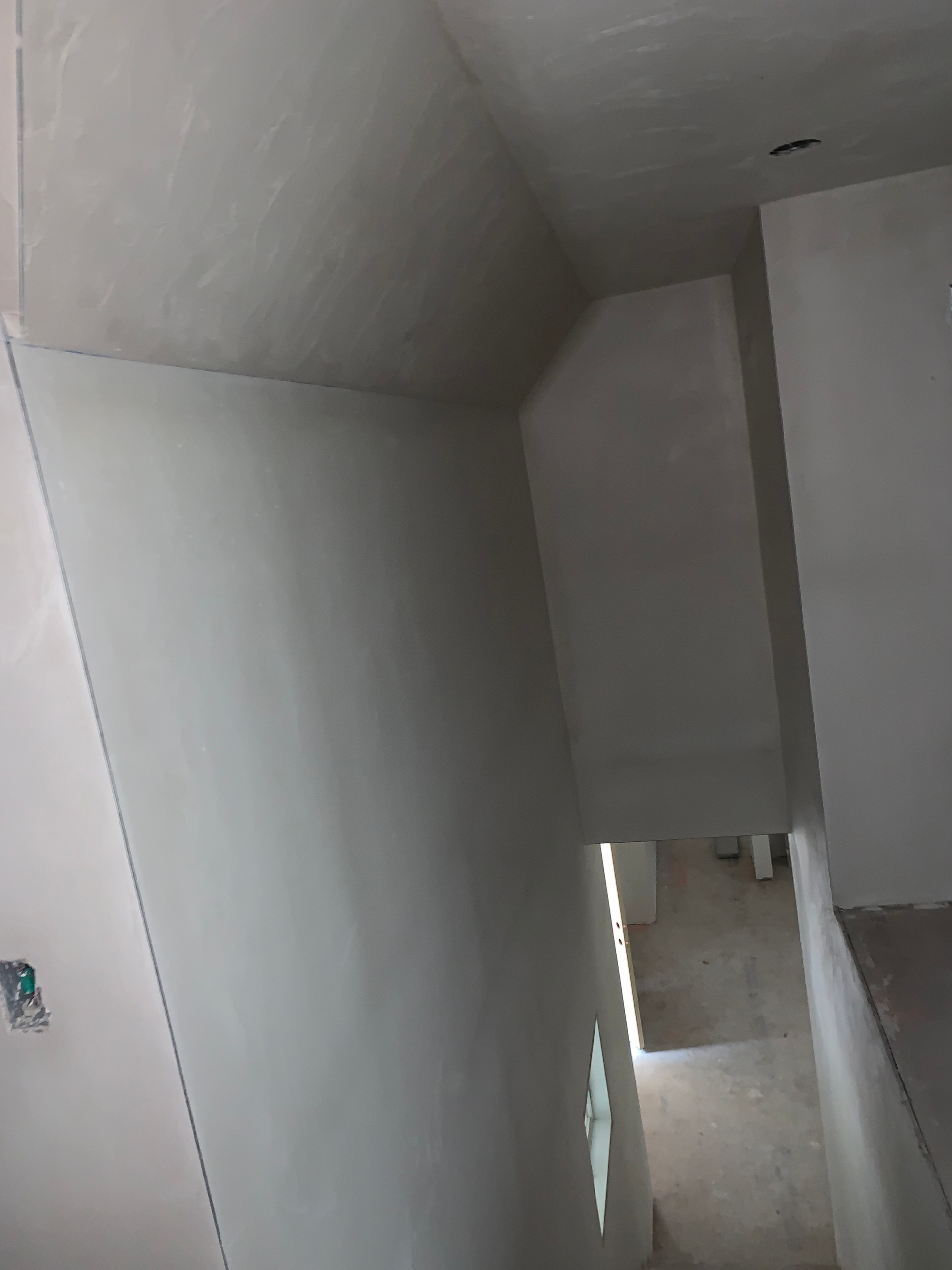 A person is walking down a set of stairs in a room.