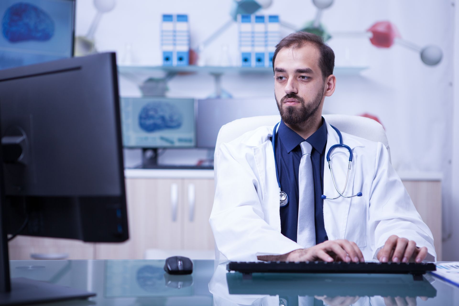 A doctor improves his workflow using advanced healthcare administrative software with analytics and reporting tools. 