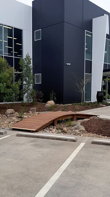 A Stone Walkway In A Garden Next To A House — Full Circle Landscaping in Uki, NSW