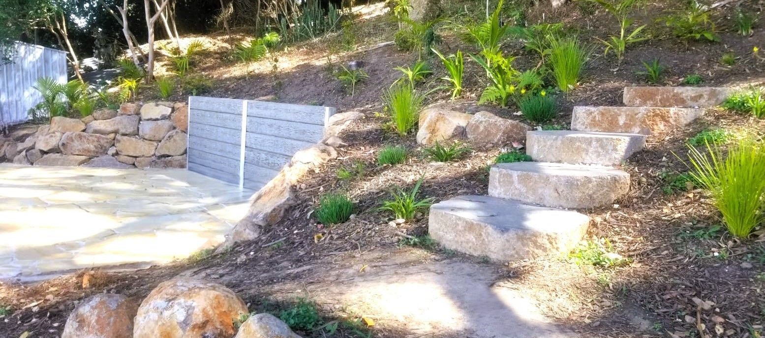 A Stone Walkway In A Garden Next To A House — Full Circle Landscaping in Uki, NSW