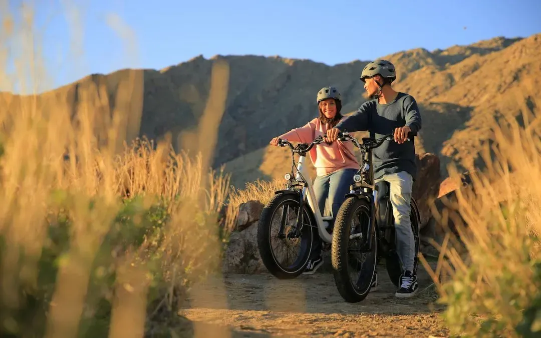 A man and a child are riding bicycles on a trail IN Denver CO