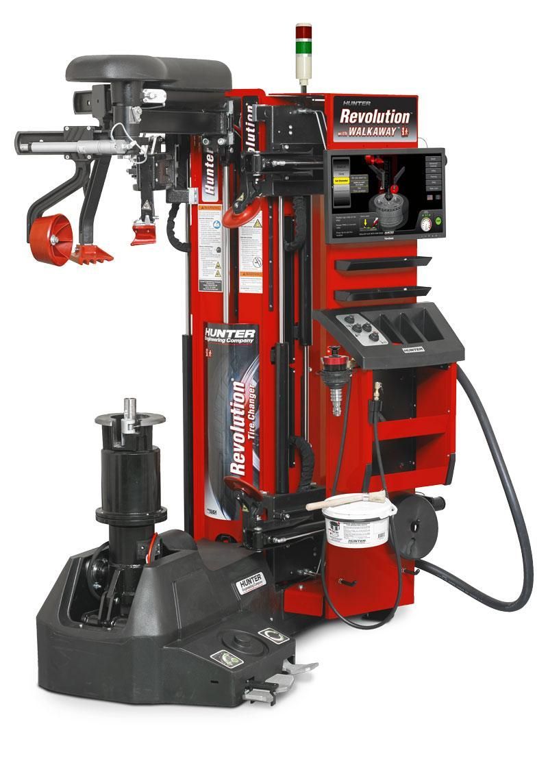 Red tire-changing machine with control panel and black wheel clamp