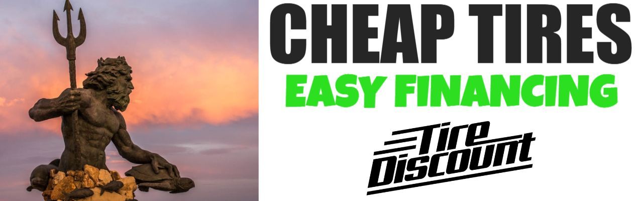 a picture of a statue next to a sign that says cheap tires easy financing
