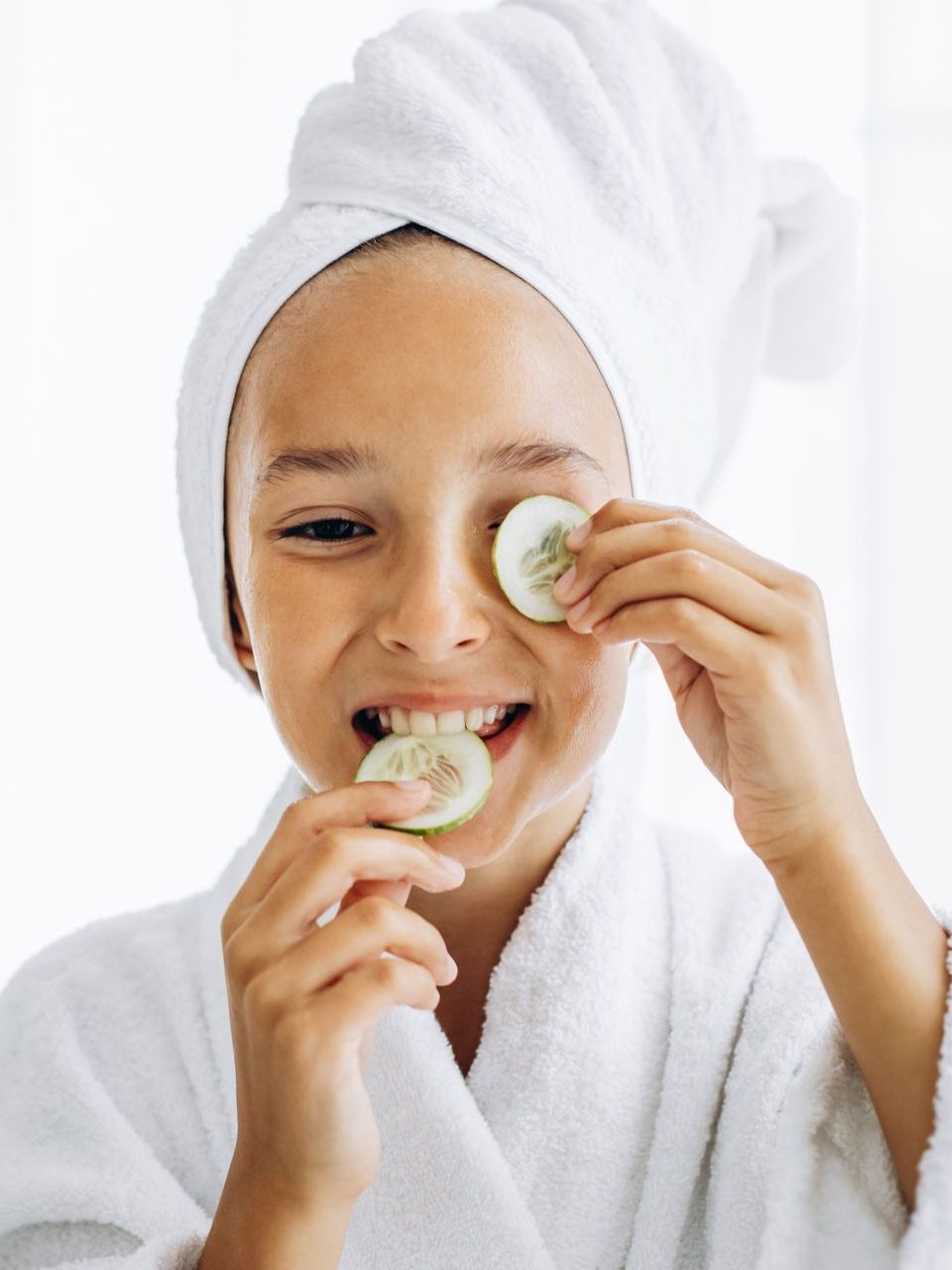 A child in a spa eating cucumber
