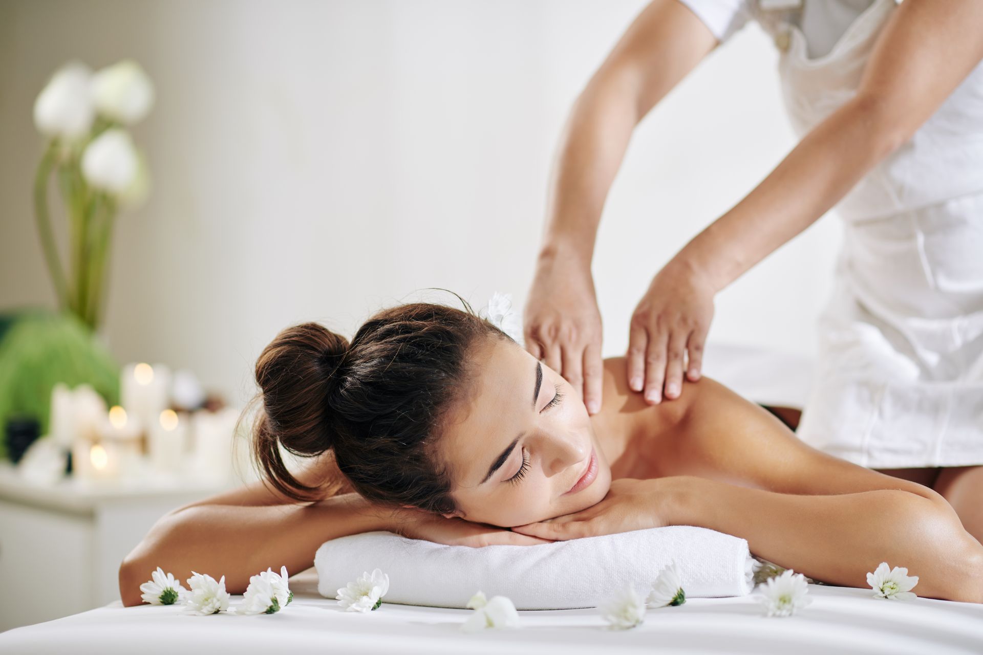 a woman is laying on a table getting a massage