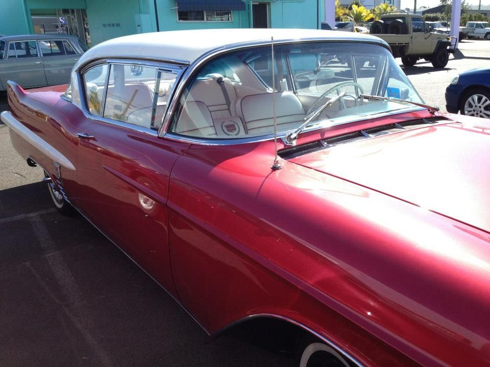 A Red Car With A White Top Is Parked In A Parking Lot — Marcoola Tyre & Mechanical In Marcoola, QLD