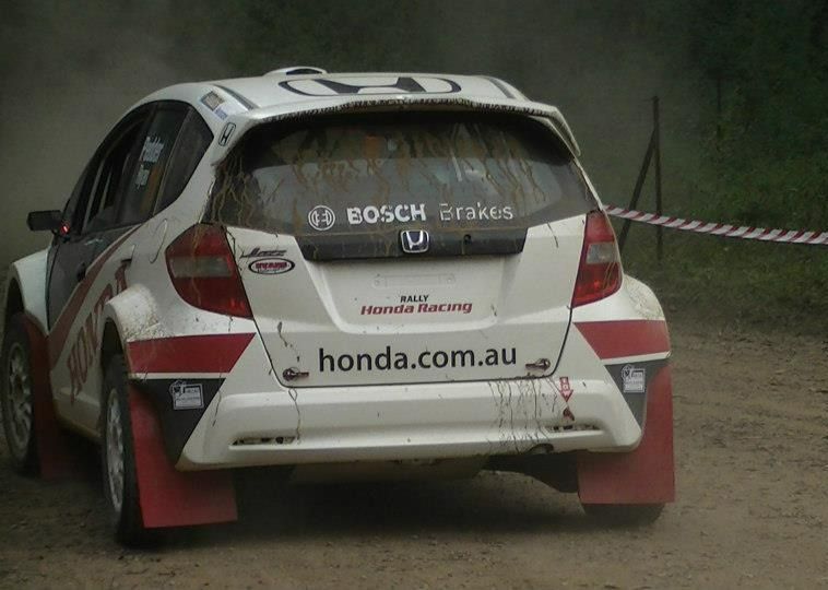 A White Honda Car Is Driving On A Dirt Road — Marcoola Tyre & Mechanical In Marcoola, QLD