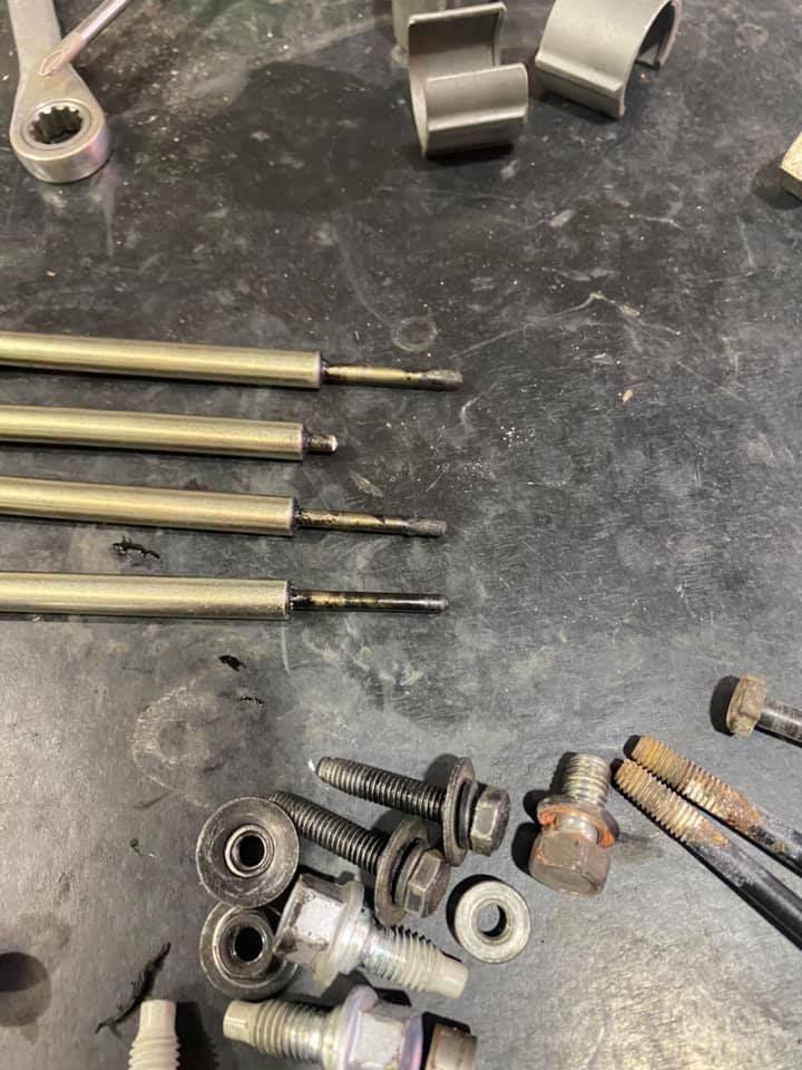 A Bunch Of Screws And Nuts Are Sitting On A Table — Marcoola Tyre & Mechanical In Marcoola, QLD