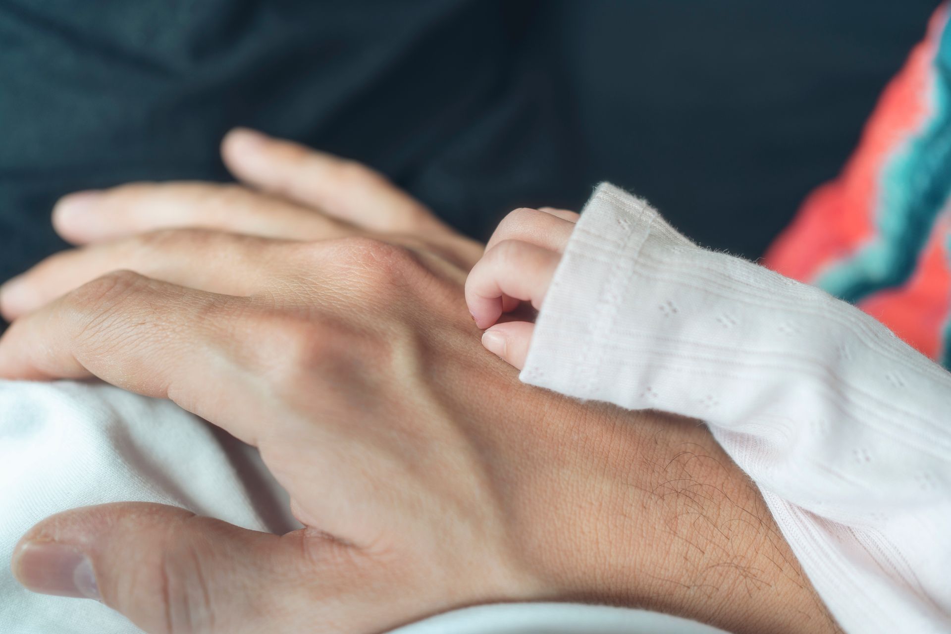 Baby and father holding hands