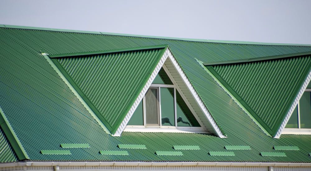 The House With A Green Roof Of Corrugated Sheet — Enduro Shield Roofing Solutions in Elanora, QLD