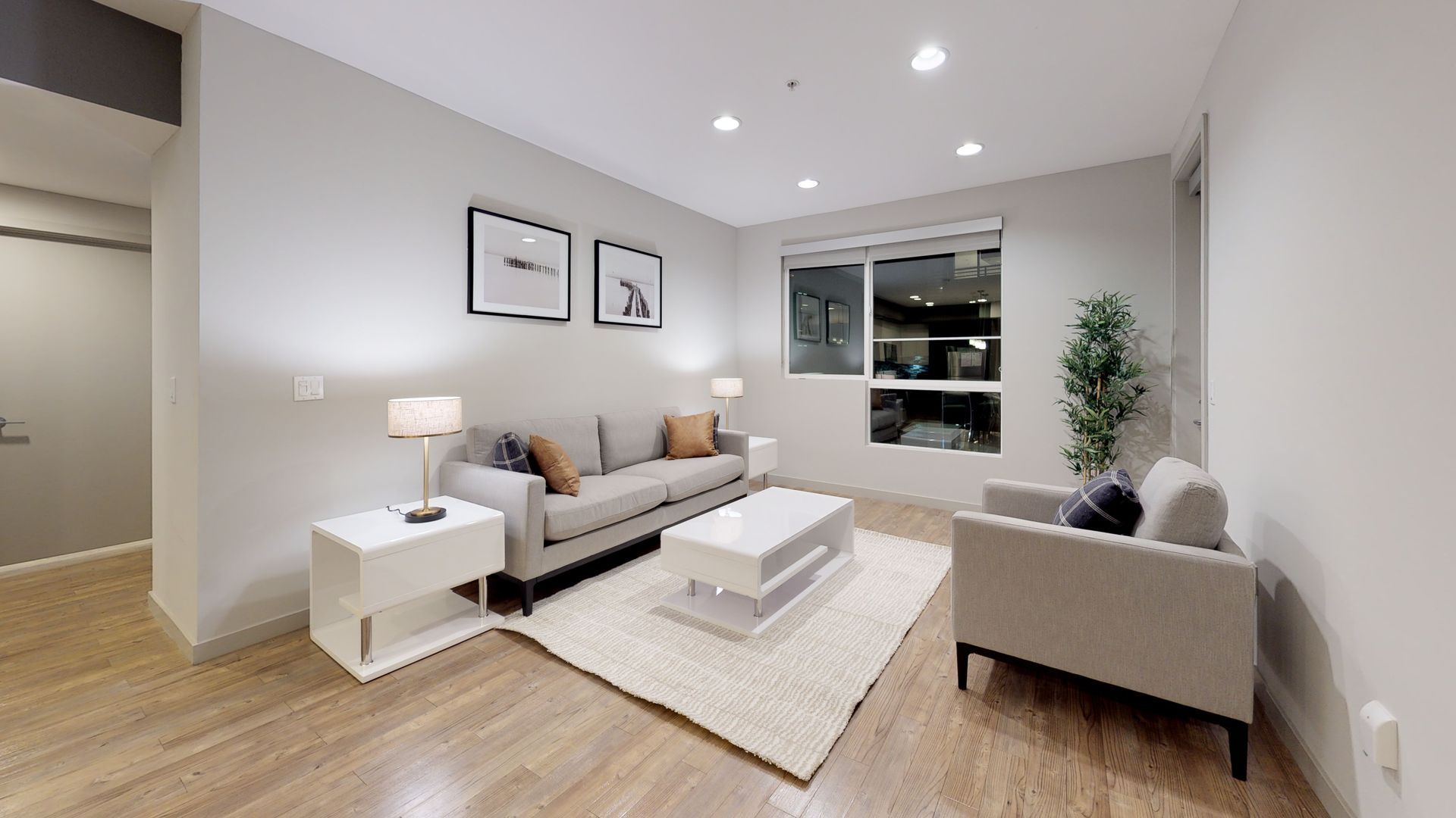 Bright, furnished apartment living room with a sofa, armchair and large window