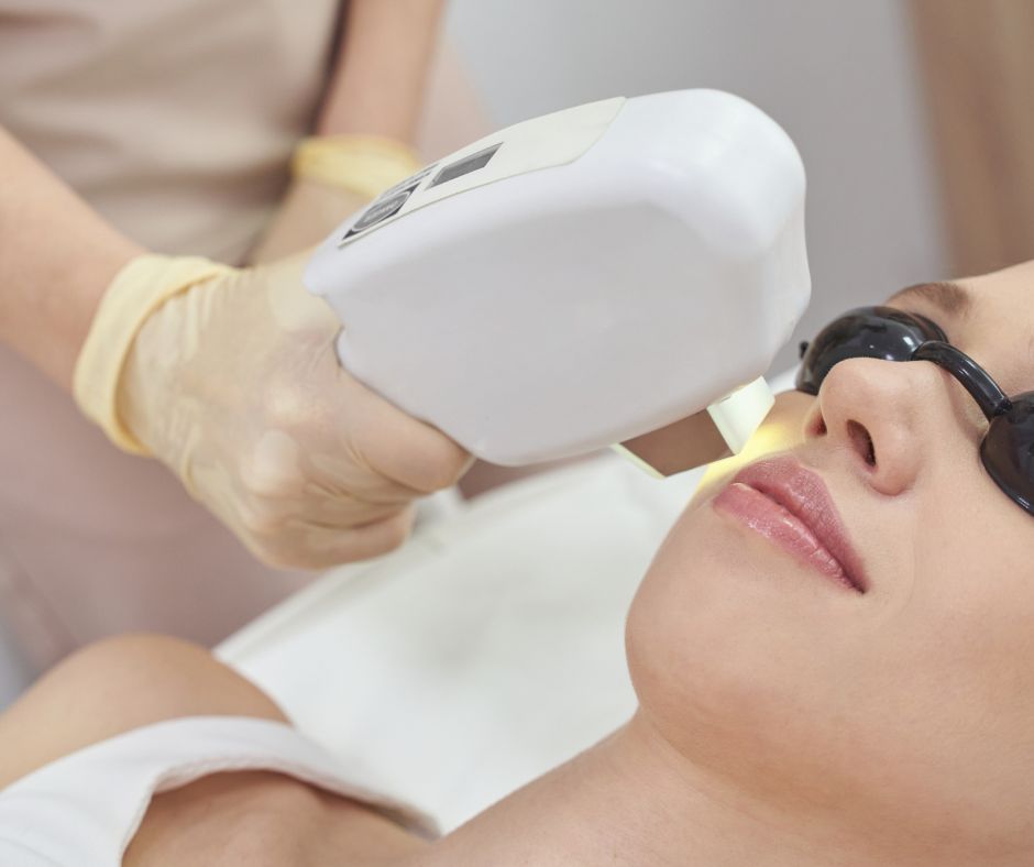 Woman Receiving Facial Treatment Device on Cheek — Hope Laser and Beauty Clinic In Tuncurry, NSW