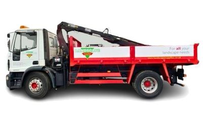 A white and red commercial truck with a mounted crane for landscape supplies, shown against a plain white background.