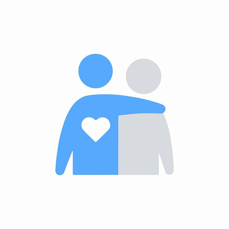 A man is hugging another man with a heart on his chest.