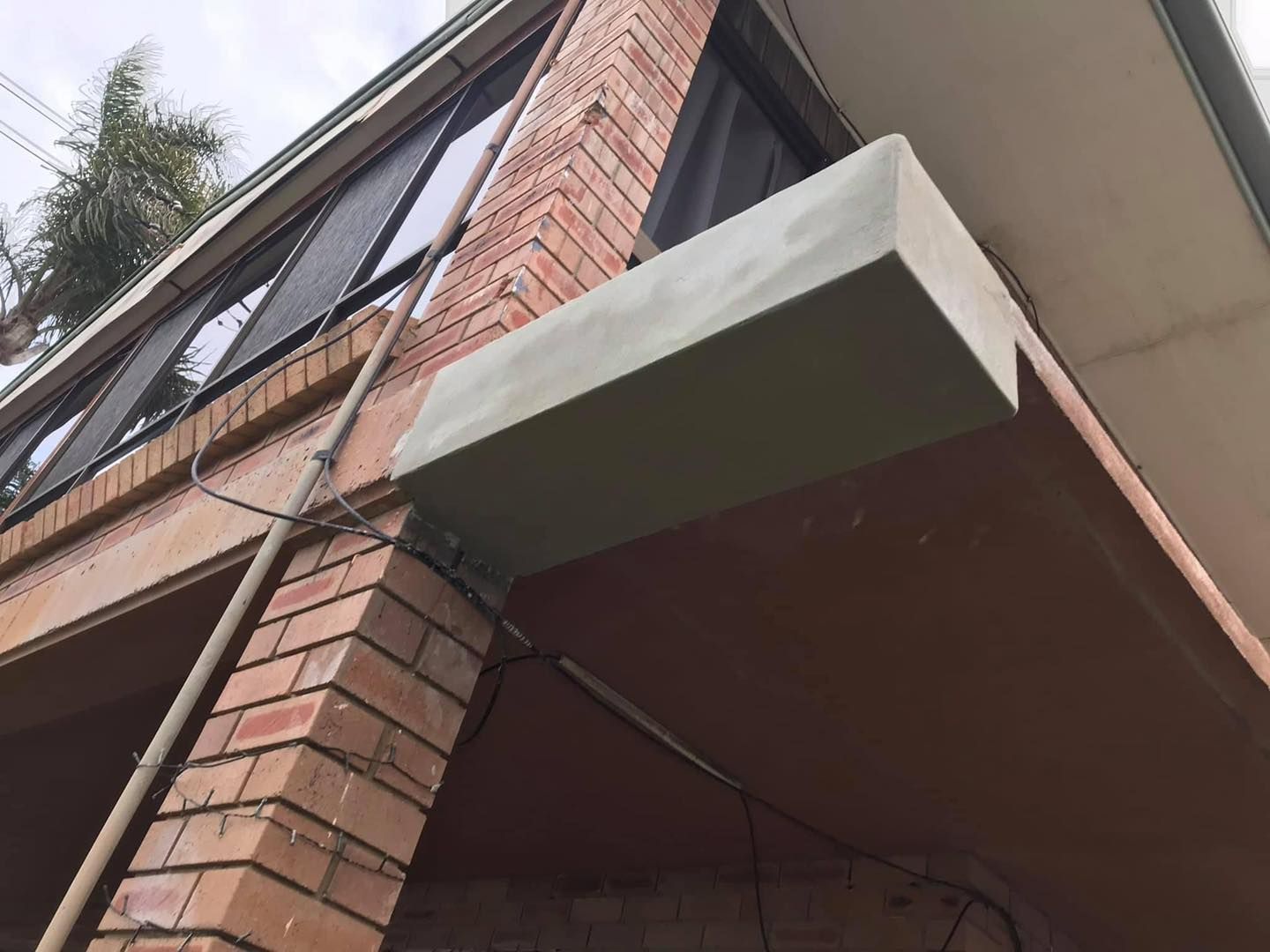 Brick building corner with masonry repair work in progress