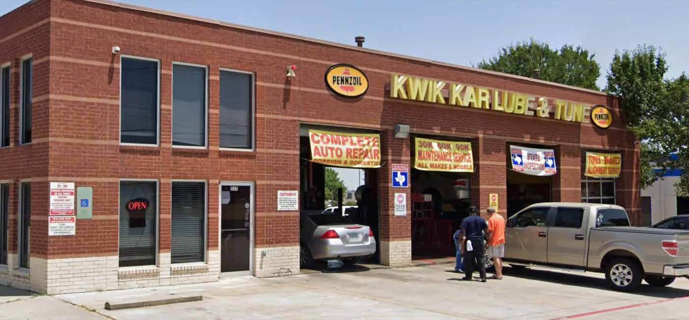 Brick storefront with open garage bays | Kwik Kar of Cedar Hill