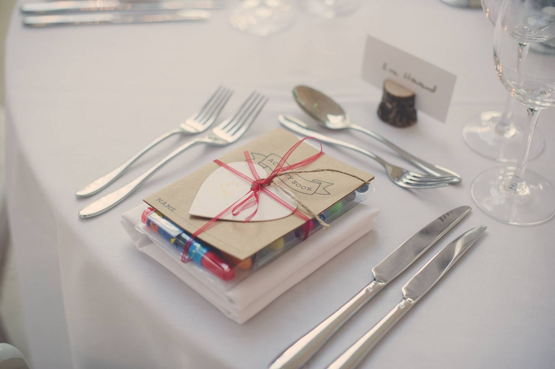 a table setting with utensils and a book on it .