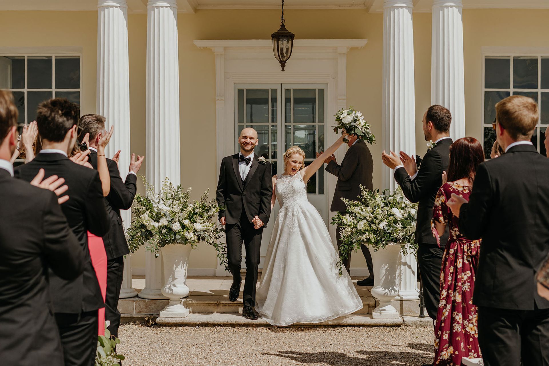 a bride and groom are walking down the aisle at their wedding .