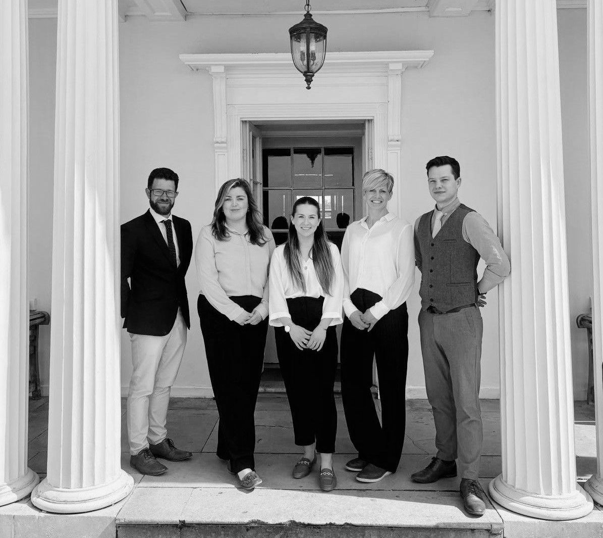 a group of people standing in front of a screen that says wedding venue of the year
