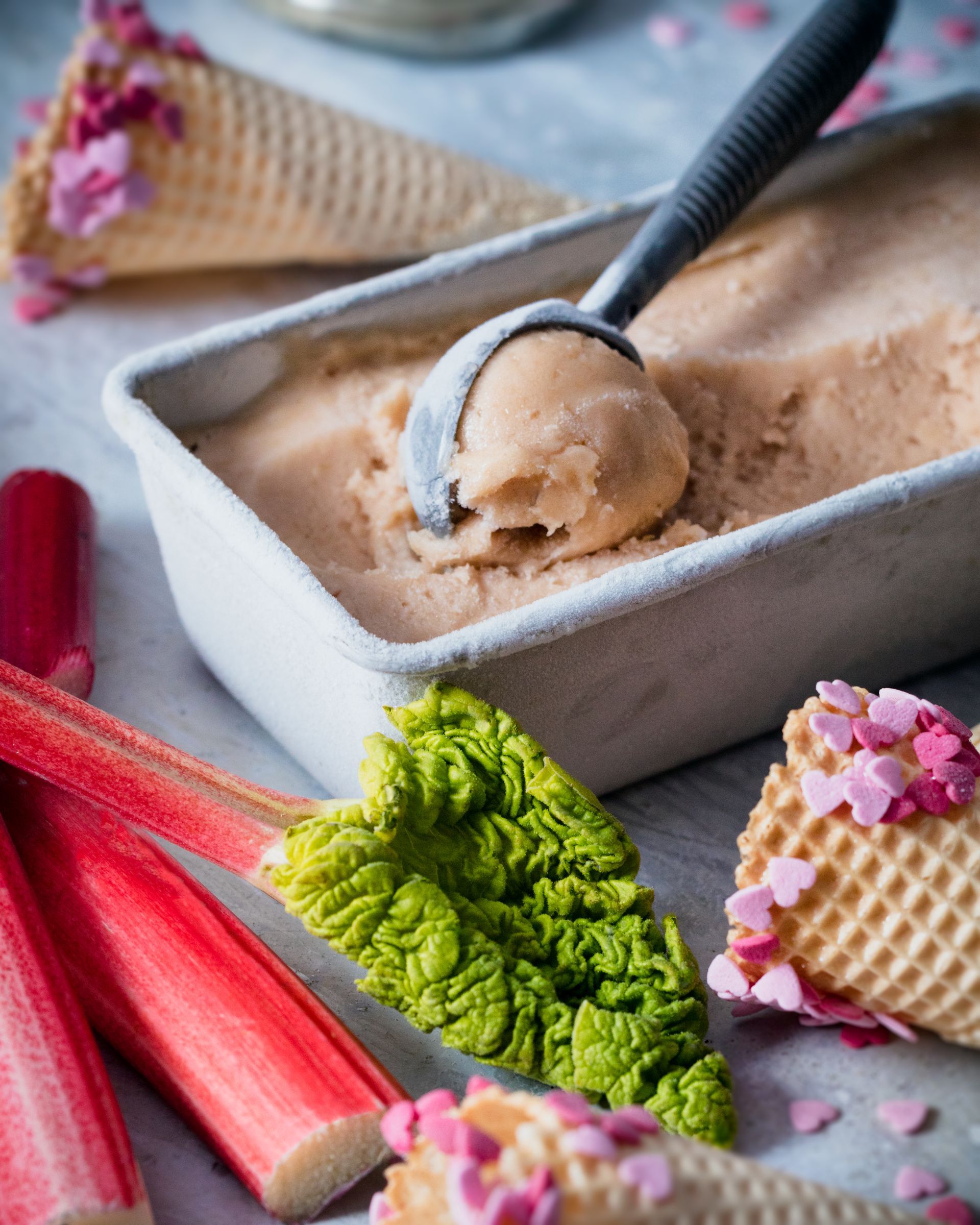 a container of rhubarb ice cream with a spoon in it